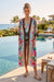 Woman in a colorful long kimono with side pockets and tassel front ties from Johnny Was
