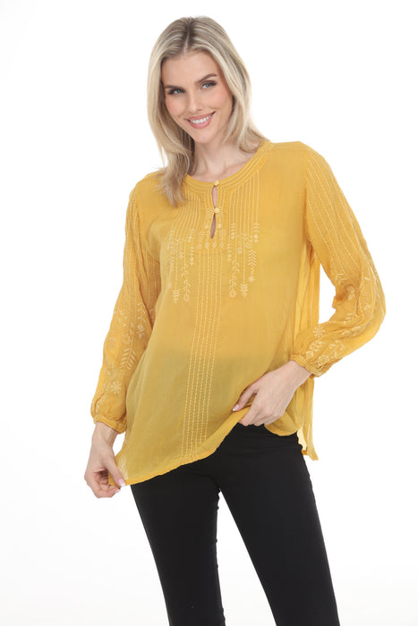 Woman wearing a yellow tunic top with tonal embroidery and bishop sleeves from Johnny Was