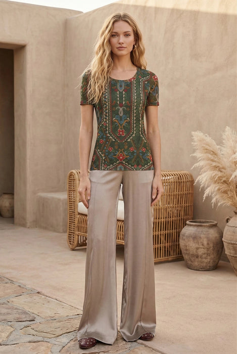 Woman wearing green short sleeve mesh tee with colorful floral and geometric patterns from Johnny Was