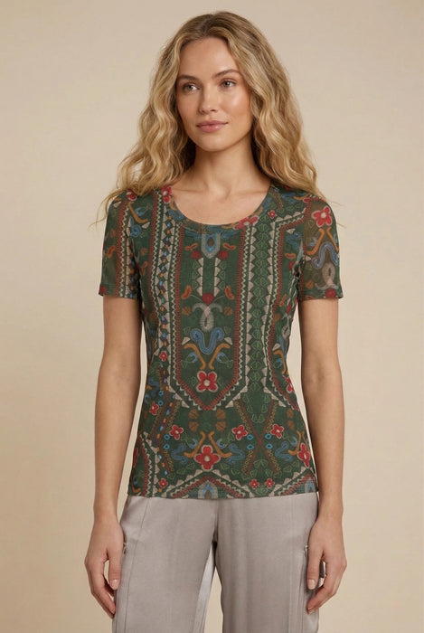 Woman wearing green short sleeve mesh tee with colorful floral and geometric patterns from Johnny Was