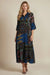 Woman wearing a colorful burnout velvet paisley patchwork patterned midi dress with 3/4 sleeves from Johnny Was