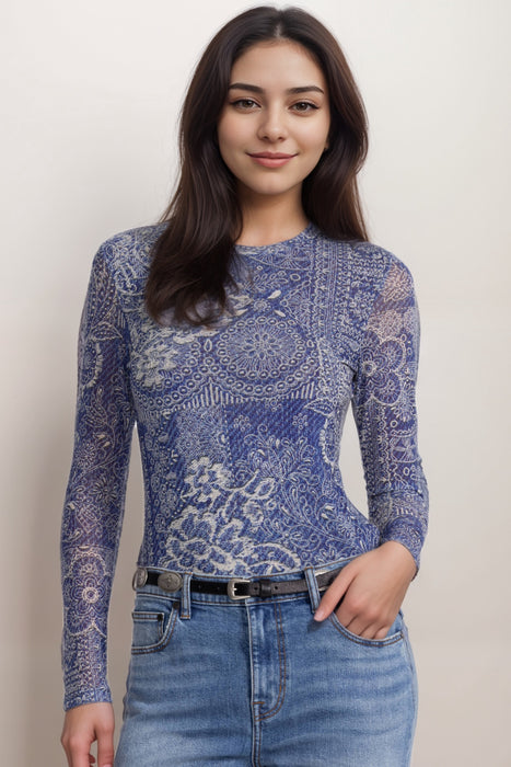 Woman wearing a blue mesh top with denim lace print and long sleeves
