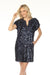 Woman wearing a navy sequin mini dress with v-neck and short sleeves from Johnny Was