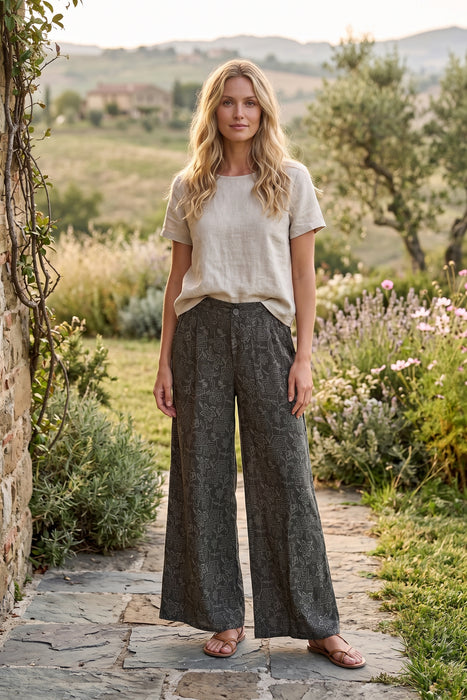 Woman wearing a green wide leg pants with tonal embroideries from Johnny Was