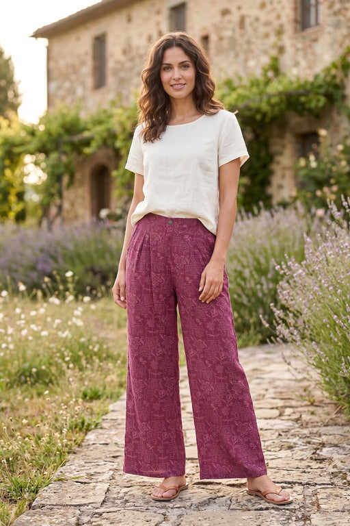 Woman wearing a purple wide leg pants with tonal embroideries from Johnny Was
