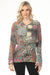 Woman wearing a colorful patterned long sleeve top with paisley and animal prints from Johnny Was