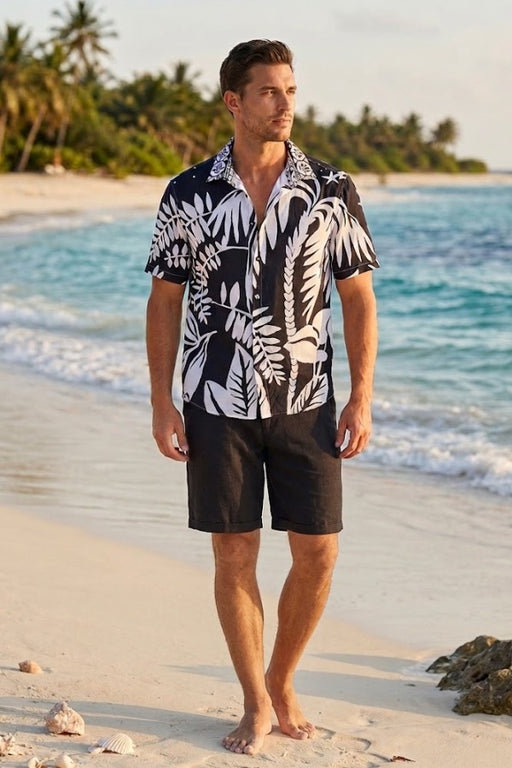 Man wearing a black and white tropical patterned shirt with short sleeves from Johnny Was