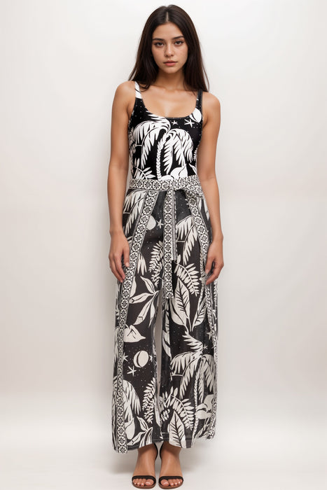Woman wearing a black and white wrap cover-up pant with tropical print and waist tie from Johnny Was