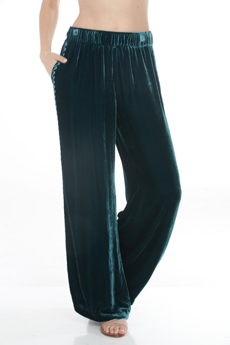 Woman wearing a teal velvet wide leg pants with side embroidery and pockets from Johnny Was
