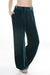 Woman wearing a teal velvet wide leg pants with side embroidery and pockets from Johnny Was