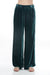 Woman wearing a teal velvet wide leg pants with side embroidery and pockets from Johnny Was