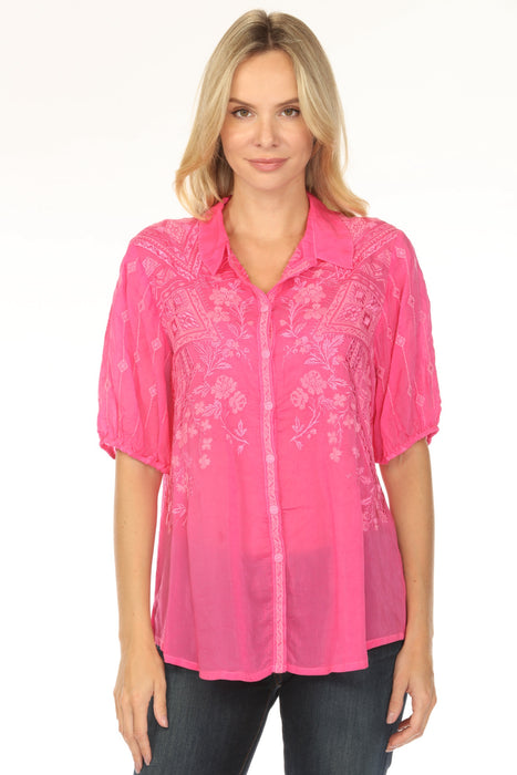 Woman wearing a pink blouse with floral embroidery and puff sleeves from Johnny Was