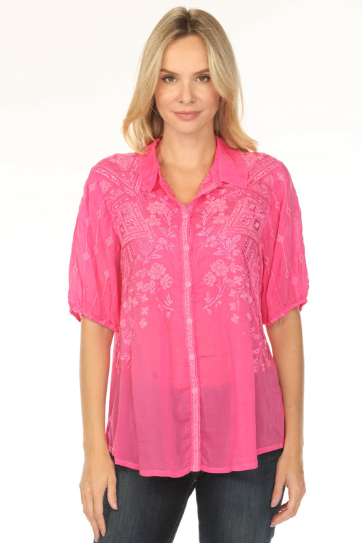 Woman wearing a pink blouse with floral embroidery and puff sleeves from Johnny Was