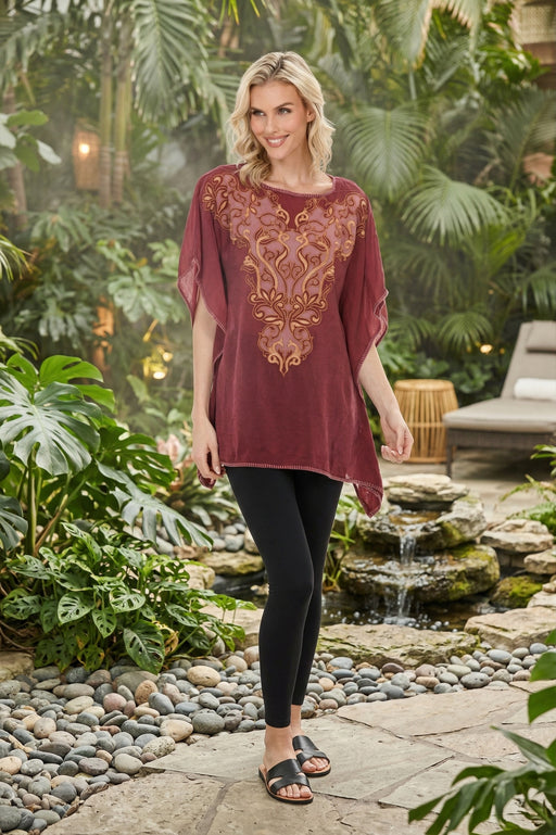 Woman wearing a Johnny Was Rebecca Poncho Lucia with intricate embroidery and batwing sleeves