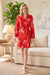 Woman wearing Johnny Was red multi sleep robe with cherry blossom and snake print