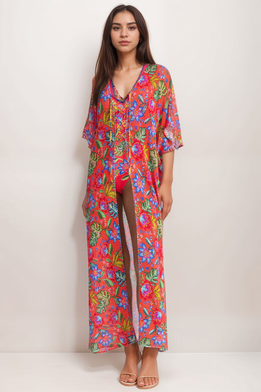 Woman wearing a colorful floral maxi kimono swimsuit cover-up from Johnny Was