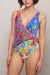 Woman wearing a colorful floral-printed one piece swimsuit from Johnny Was