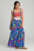 Woman wearing a blue floral-printed cover-up pant with tiered flared leg from Johnny Was