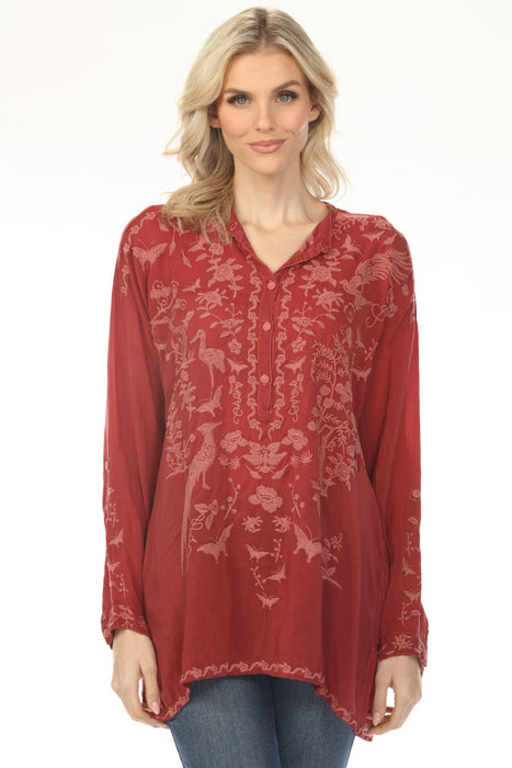 Woman wearing a red embroidered tunic top with long sleeves from Johnny Was