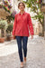Woman in a red embroidered shirt with lace hem trim and long sleeves from Johnny Was