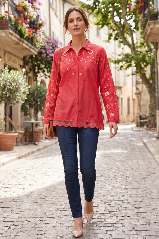 Woman in a red embroidered shirt with lace hem trim and long sleeves from Johnny Was