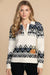 Woman wearing a Fair isle patterned pullover polo sweater with floral embroidery from Johnny Was
