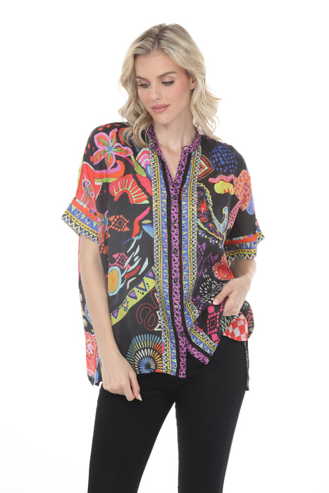 Woman wearing a colorful patterned button down shirt with short sleeves from Johnny Was