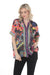 Woman wearing a colorful patterned button down shirt with short sleeves from Johnny Was
