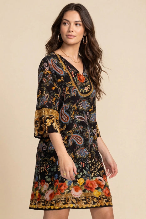 Woman wearing a black shift dress with colorful floral and paisley pattern from Johnny Was