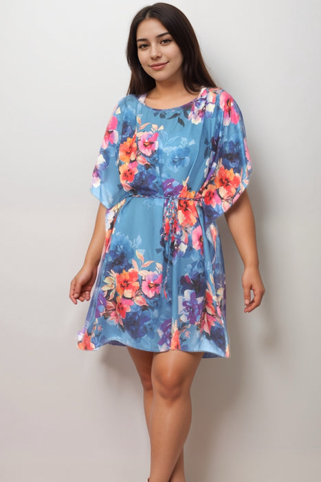 Woman wearing a blue floral-printed dress with braided waist tie from Johnny Was