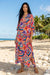 Woman wearing a colorful stripes and floral printed maxi kaftan dress from Johnny Was