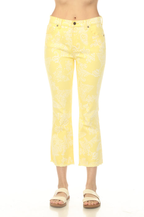 Model wearing a yellow cropped baby boot jean with floral and butterfly print from Johnny Was