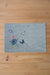 A blue , rectangle, denim placemat with floral and butterfly embroideries
