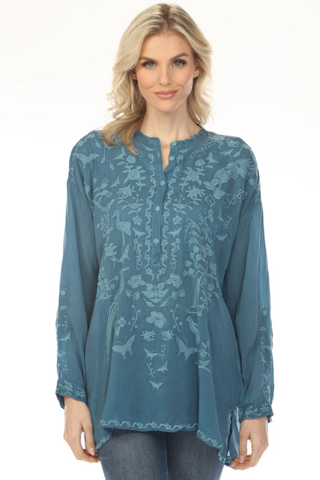 Woman wearing a teal embroidered tunic top with long sleeves from Johnny Was