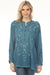Woman wearing a teal embroidered tunic top with long sleeves from Johnny Was