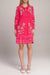 Woman wearing a pink floral-embroidered mini dress with scallop hem from Johnny Was
