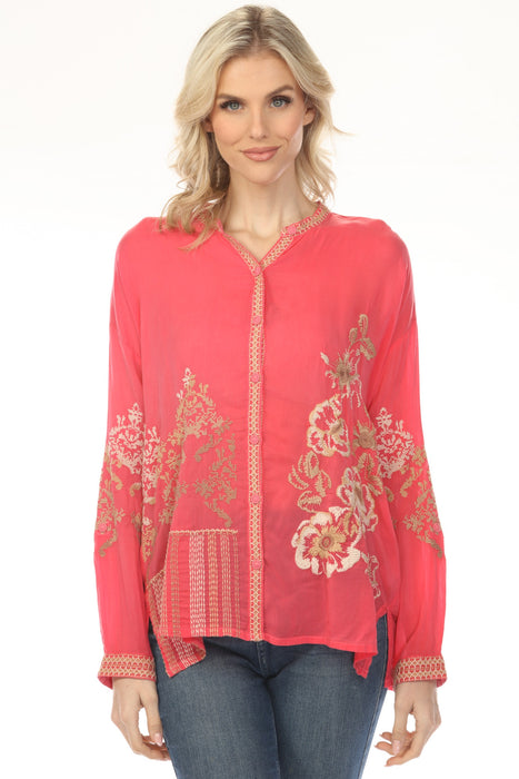Woman wearing a coral long sleeve blouse with floral embroidery and button front from Johnny Was