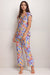 Woman wearing a colorful floral pajama set from Johnny Was