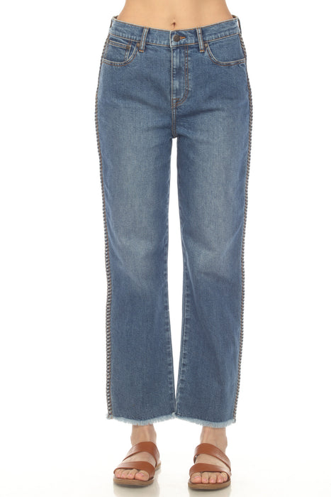 Woman wearing a denim blue jean with ankle length straight leg, braided outseam, and frayed hem from Johnny Was