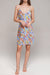 Woman wearing a colorful floral slip dress with spaghetti straps from Johnny Was
