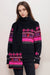 Woman wearing a black sweater and scarf with love and pink and red fair isle pattern