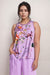 Woman wearing a purple sleeveless top with floral design from Johnny Was