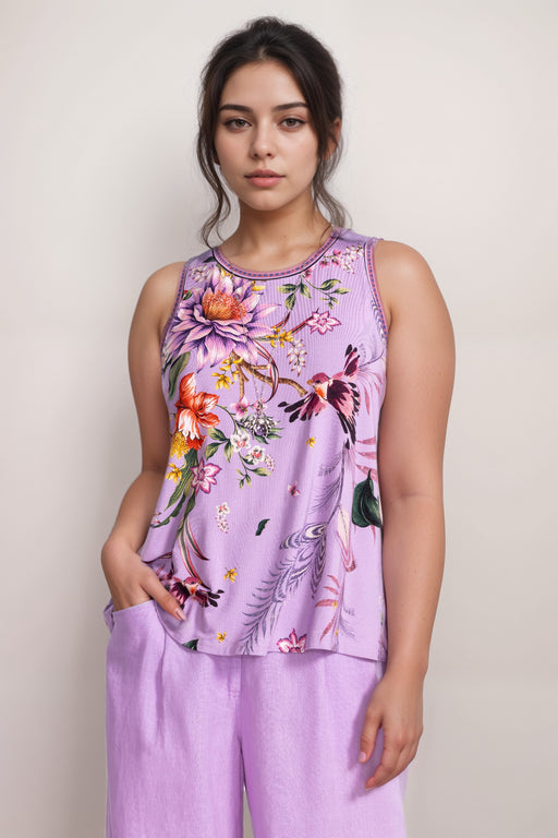 Woman wearing a purple sleeveless top with floral design from Johnny Was