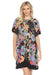 Woman wearing a colorful floral printed shift dress with short flutter sleeves