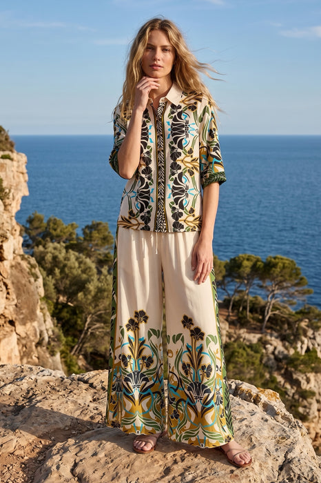 Woman wearing a patterned shirt with button front and 3/4 sleeves from Johnny Was
