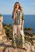 Woman wearing a patterned shirt with button front and 3/4 sleeves from Johnny Was