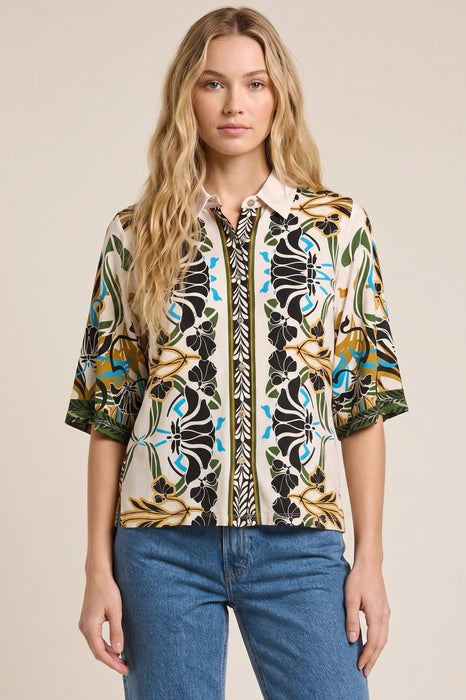 Woman wearing a patterned shirt with button front and 3/4 sleeves from Johnny Was
