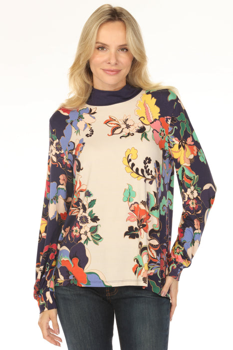 Woman wearing a colorful floral-patterned top with mock neck and puff sleeves from Johnny Was