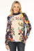 Woman wearing a colorful floral-patterned top with mock neck and puff sleeves from Johnny Was