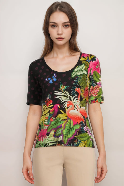 Woman wearing a colorful tropical-themed t-shirt with scoop neck from Johnny Was